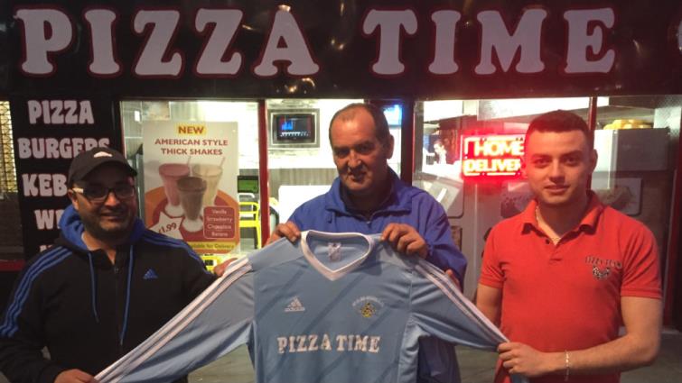 Merlins Bridge U16s coach Steve Price (centre) is pictured at the official hand over of the kit at the Pizza Time premises on Castle Square, Haverfordwest.
